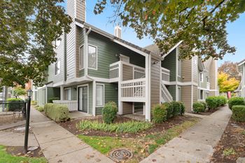 Apartment building with a green and beige exterior.